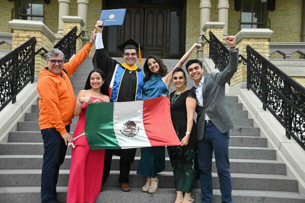 Eduardo poses with his family after graduating with his graduate degree from Notre Dame